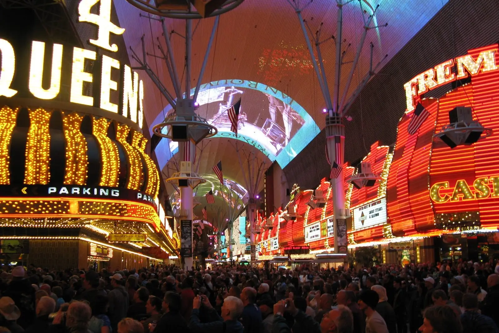 Crowds under the Fremont Street Experience canopy, surrounded by vintage casino neon in downtown Las Vegas.