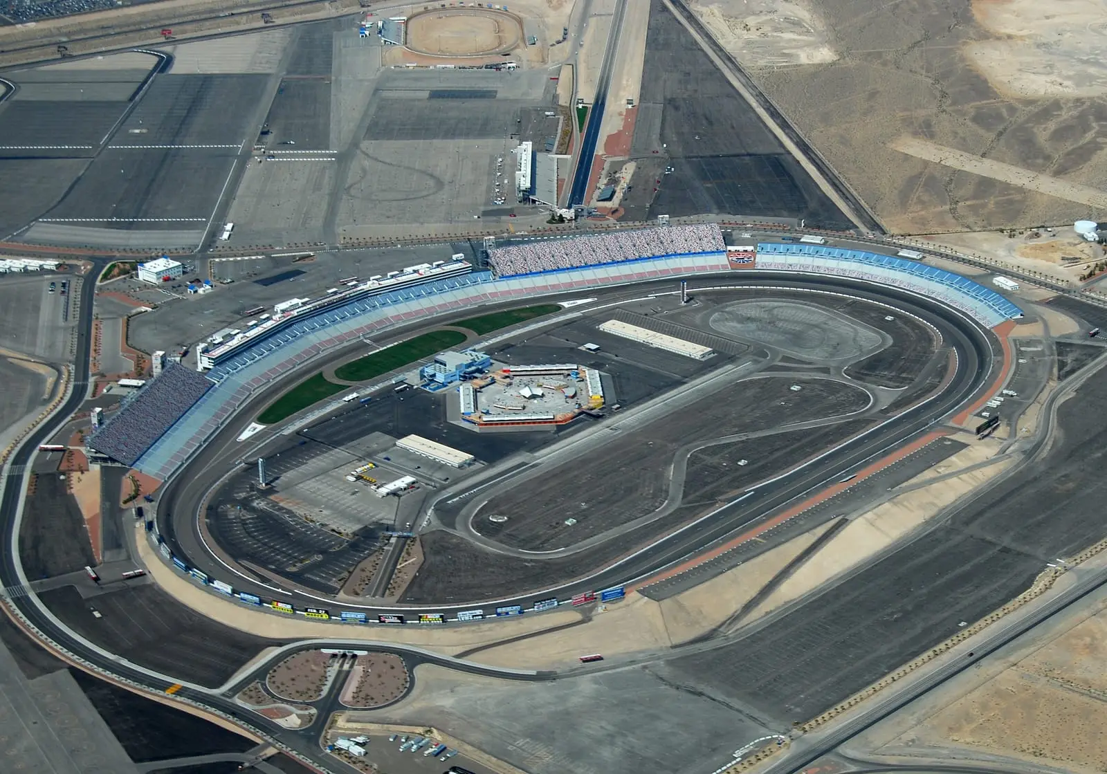 Aerial view of Las Vegas Motor Speedway's 1.5-mile oval with the dirt track and drag strip beside it.