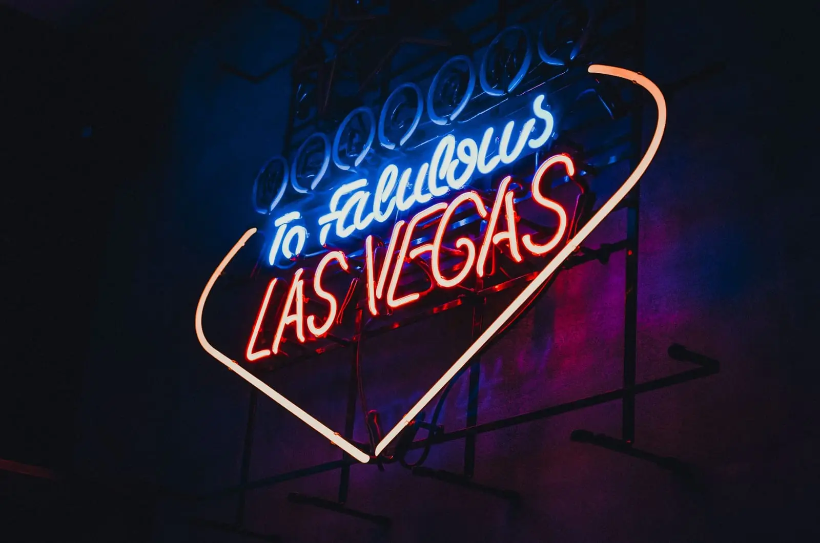 A pink and blue neon sign reading to Fabulous Las Vegas on a dark wall.