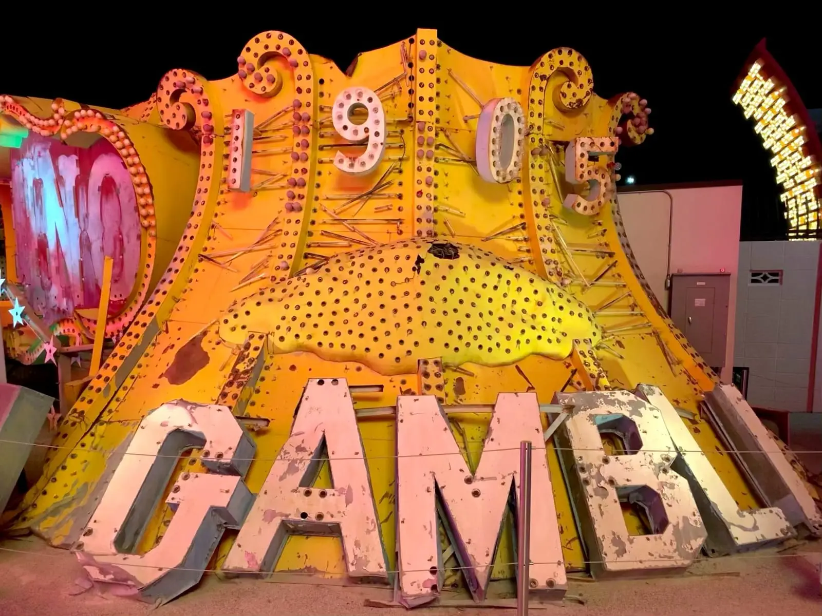 The vintage Golden Nugget sign lit up in the Neon Museum boneyard.