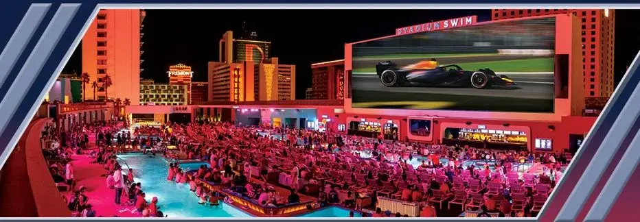 Stadium Swim at Circa: pools facing a giant screen showing F1 cars