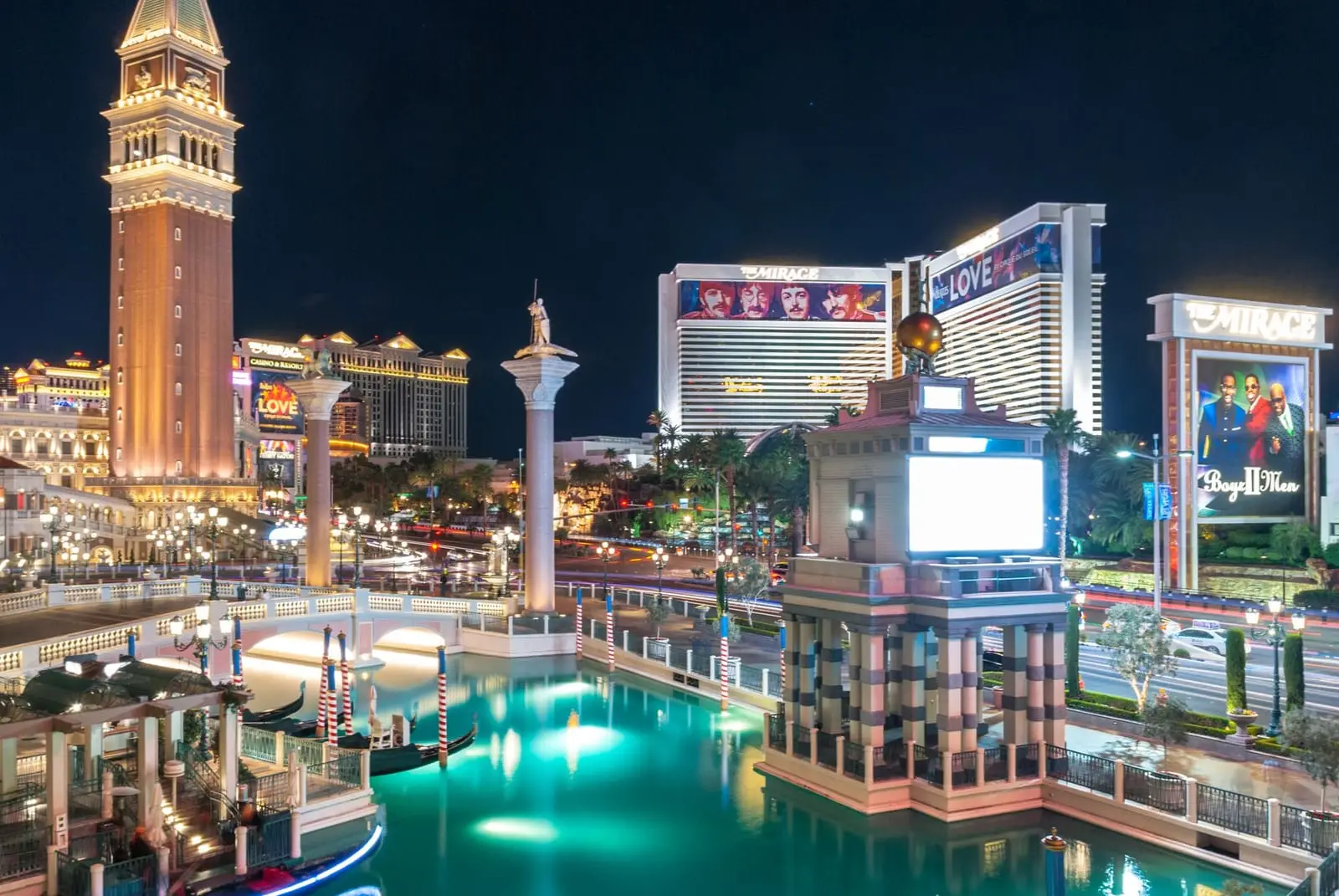 The Venetian's bell tower and canal at blue hour with Strip towers behind.